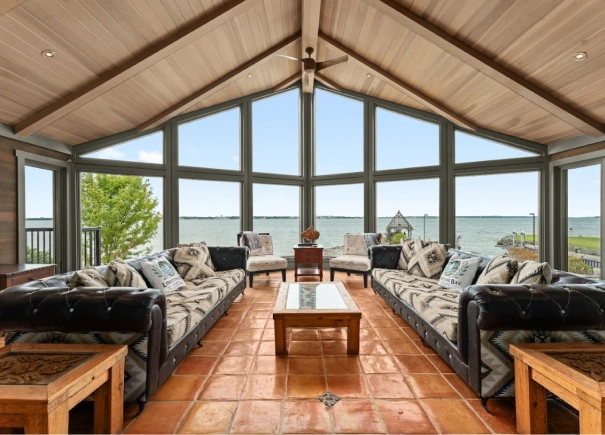 Large living room in cottage featuring large floor to ceiling windows